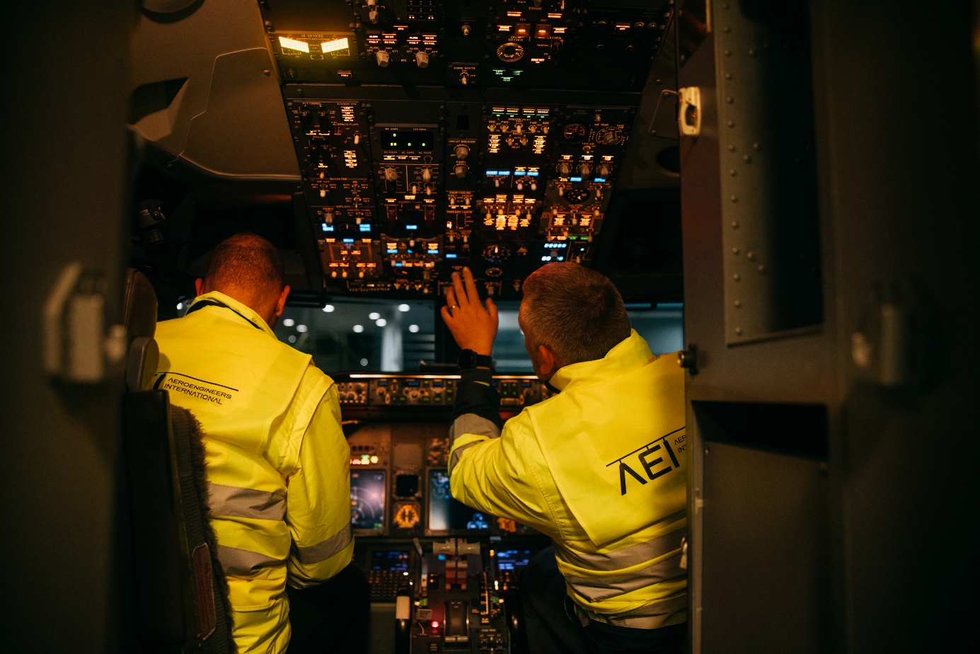 Two AEI technicians working in an aircraft cockpit