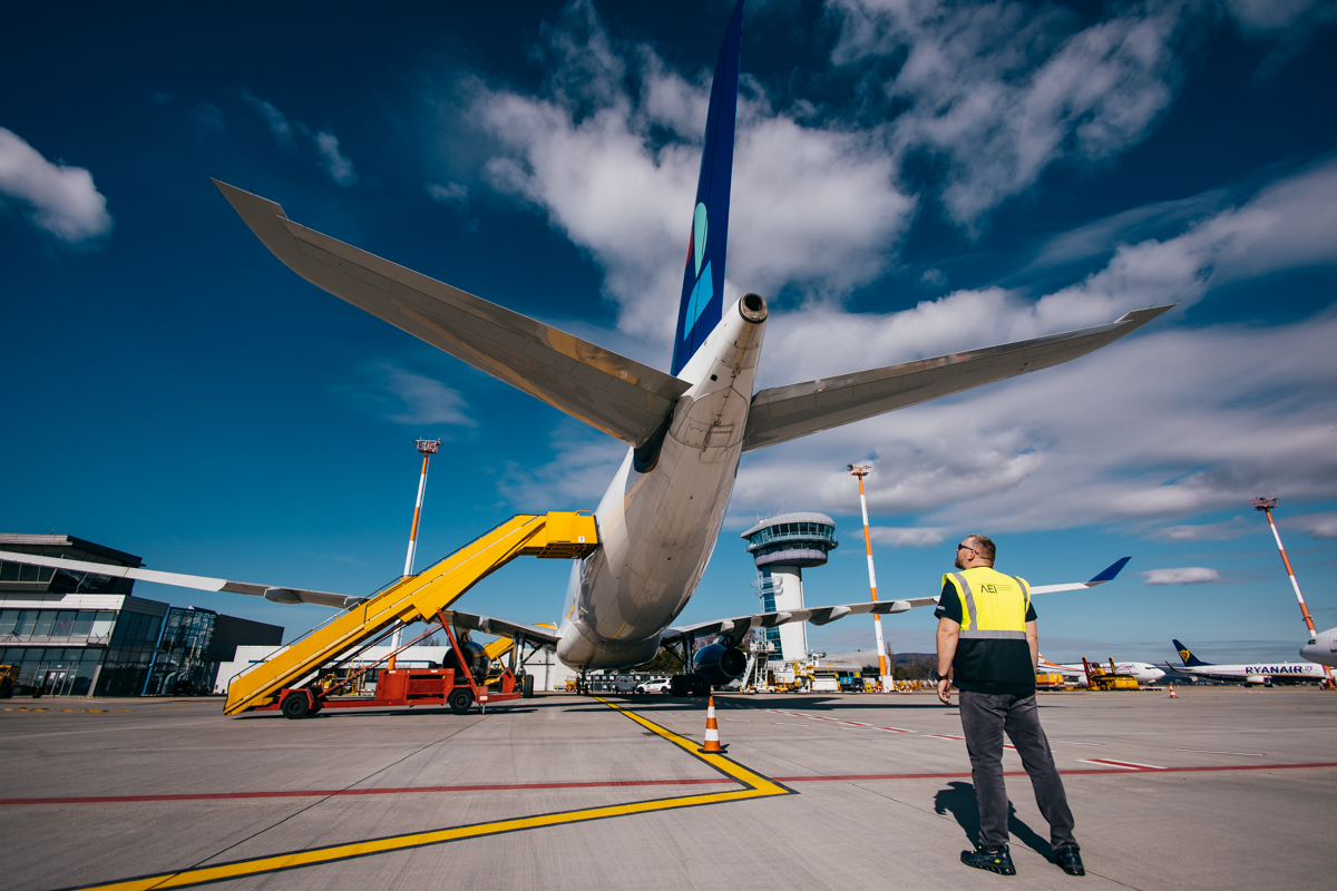 AEI technician looking up at an aircraft tail